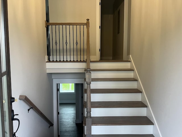 stairs featuring hardwood / wood-style floors