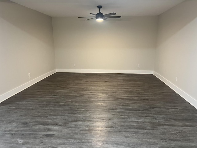 unfurnished room with dark wood-type flooring and ceiling fan