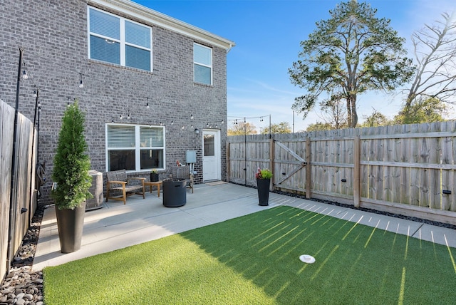 back of house with a yard, central AC unit, and a patio area