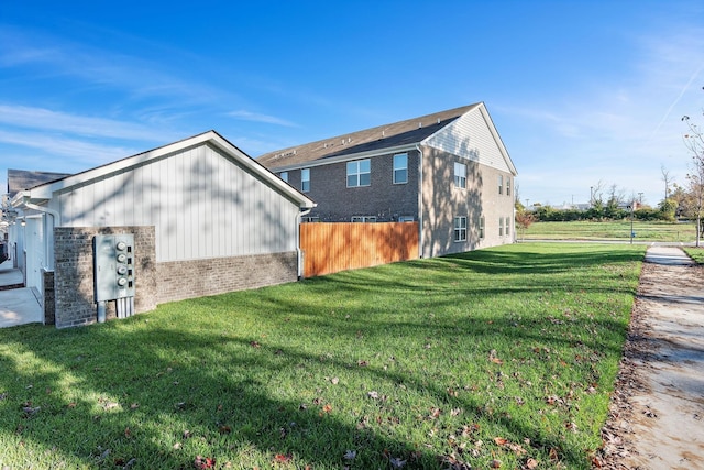 view of side of home with a lawn