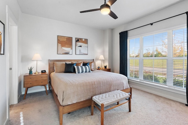 bedroom featuring ceiling fan and carpet