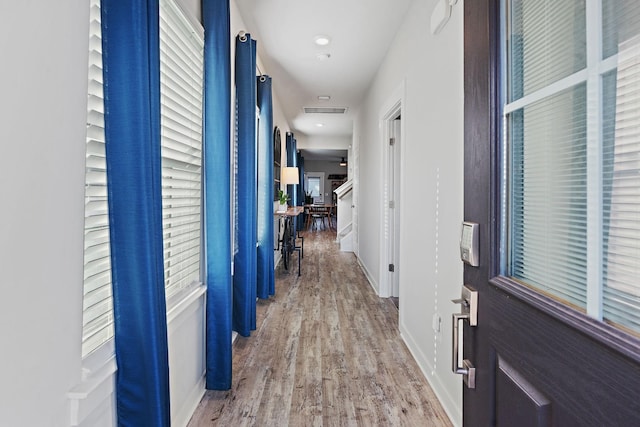 hall with light hardwood / wood-style floors