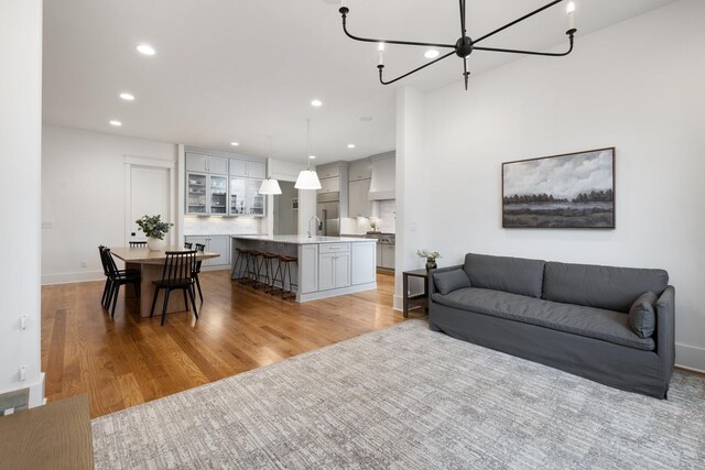 living room featuring an inviting chandelier and light hardwood / wood-style floors