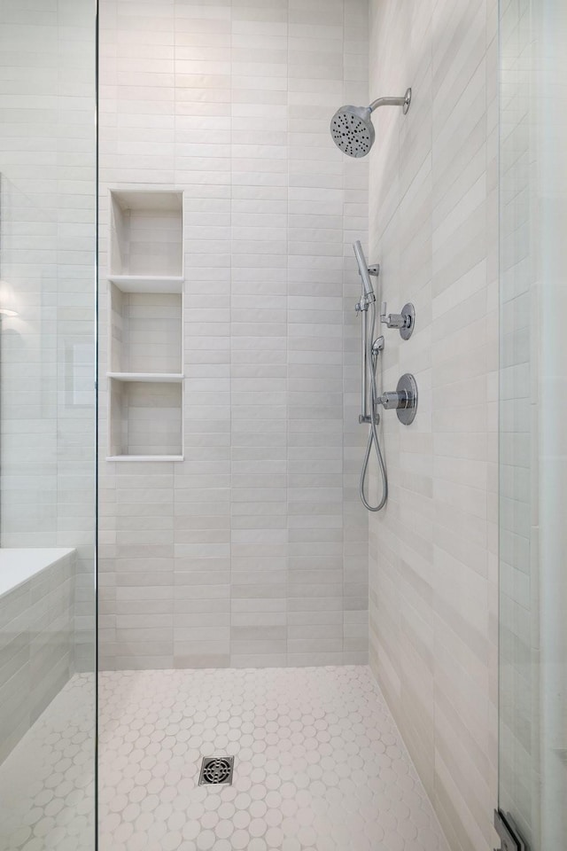 bathroom with a tile shower