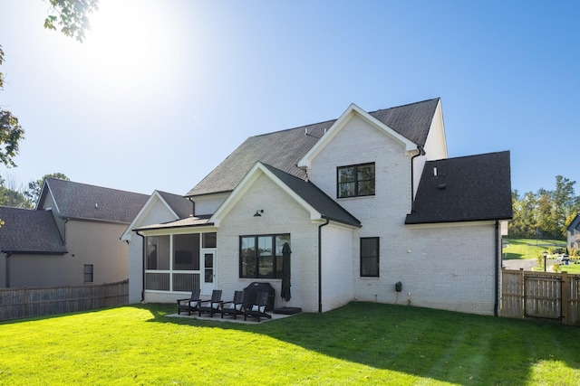 back of house with a patio, a sunroom, and a yard