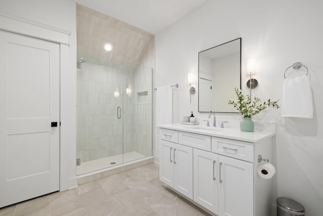 bathroom featuring vanity and a shower with shower door