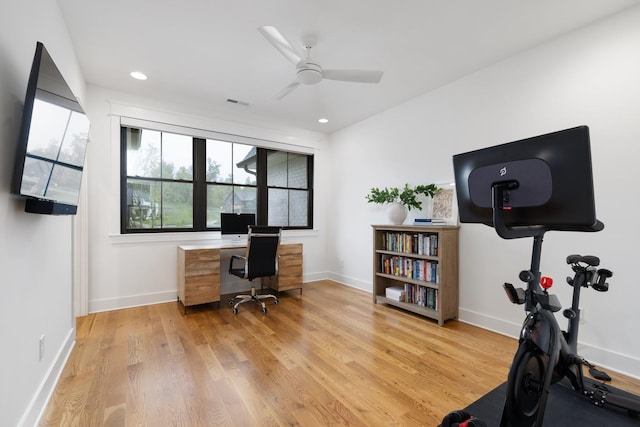 office with ceiling fan and light hardwood / wood-style floors