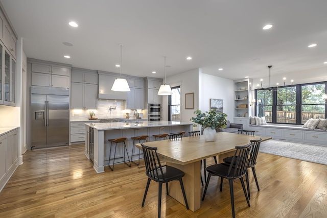 dining area featuring an inviting chandelier and light hardwood / wood-style floors