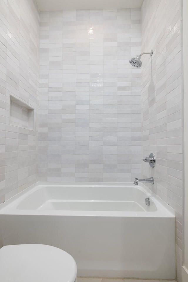 bathroom with shower / washtub combination and toilet