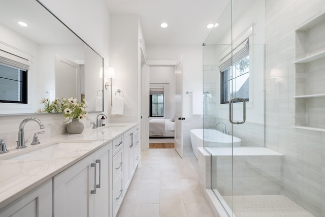 bathroom with tile patterned flooring, vanity, and walk in shower