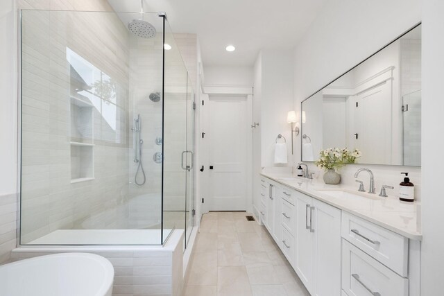 bathroom featuring vanity, tile patterned flooring, and separate shower and tub