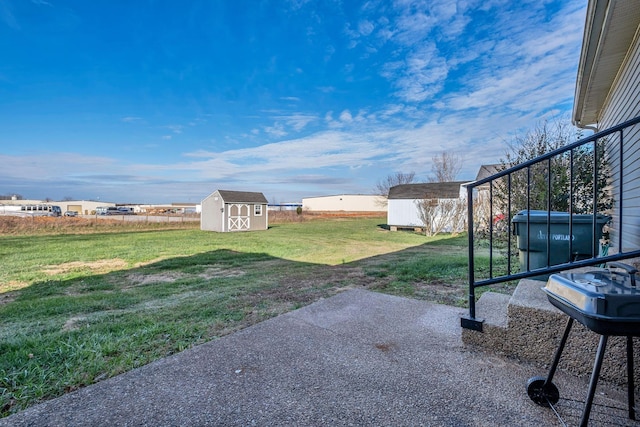 view of yard featuring a storage unit and a patio area