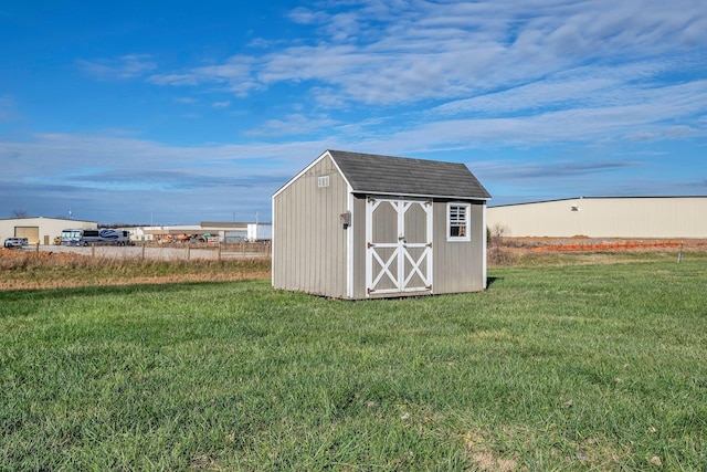 view of outbuilding featuring a yard