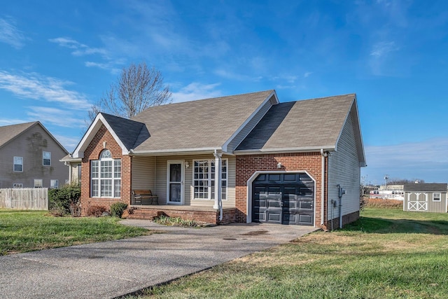 view of front of home featuring covered porch, a garage, and a front lawn