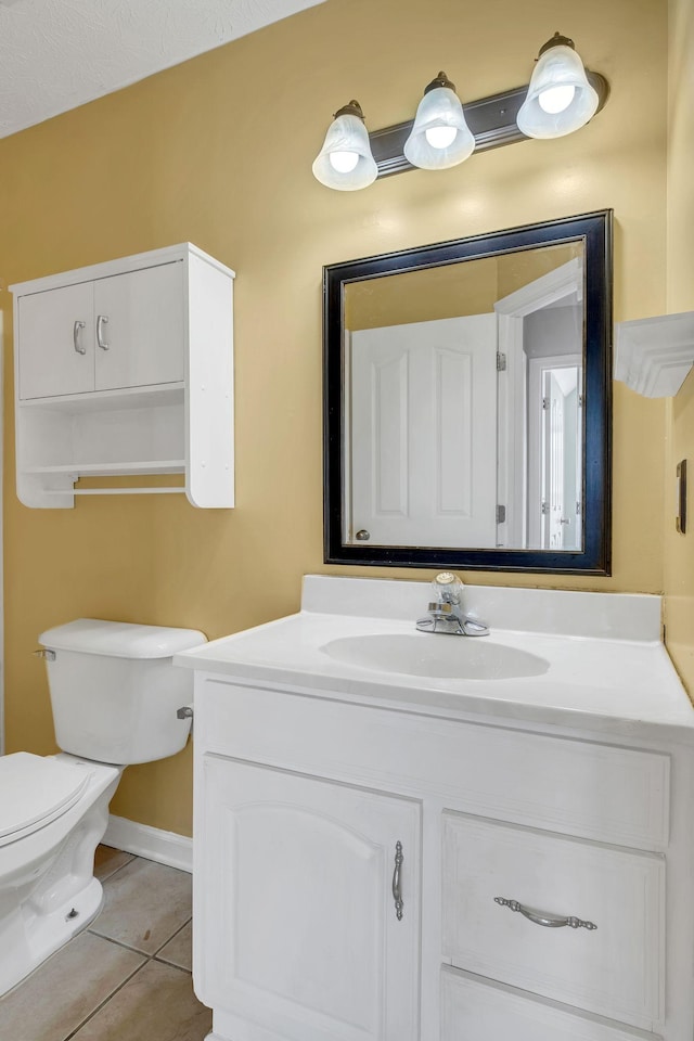 bathroom featuring tile patterned floors, vanity, and toilet