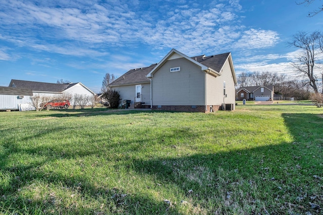 view of home's exterior featuring a yard and central AC