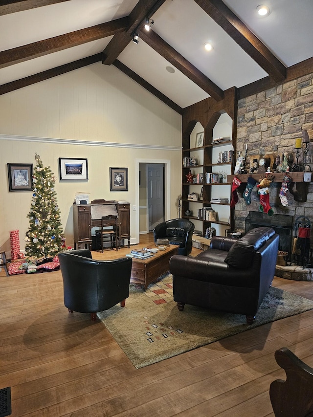 living room with beam ceiling, hardwood / wood-style flooring, and high vaulted ceiling