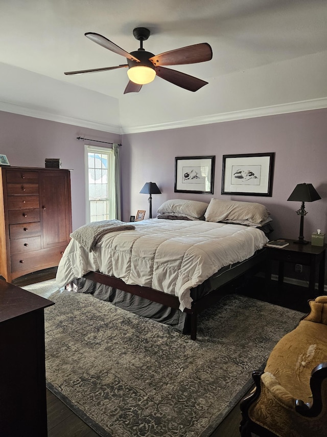 bedroom featuring ceiling fan, dark hardwood / wood-style floors, and crown molding