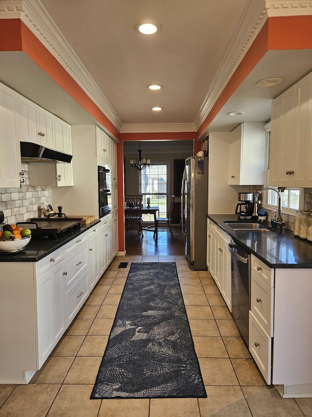 kitchen with black appliances, sink, a notable chandelier, light tile patterned flooring, and white cabinetry