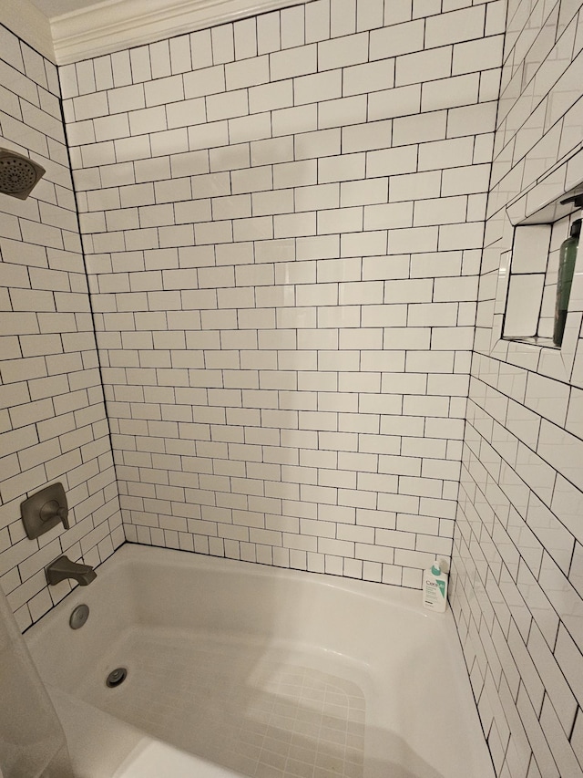 bathroom featuring tiled shower / bath combo and ornamental molding