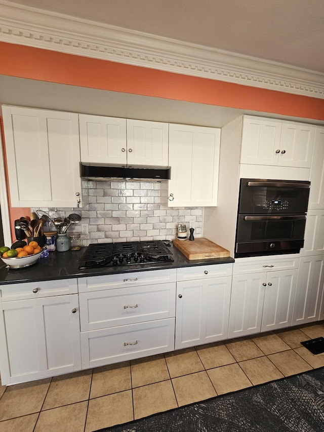 kitchen with backsplash, crown molding, black appliances, light tile patterned floors, and white cabinetry