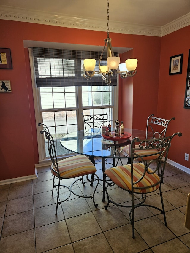 dining area with crown molding, dark tile patterned floors, and an inviting chandelier