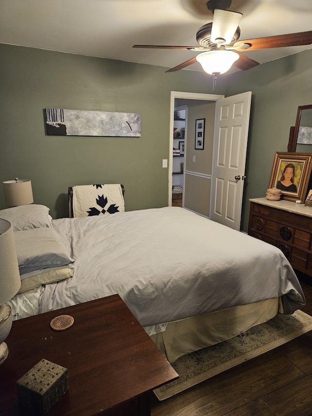 bedroom with dark hardwood / wood-style flooring and ceiling fan