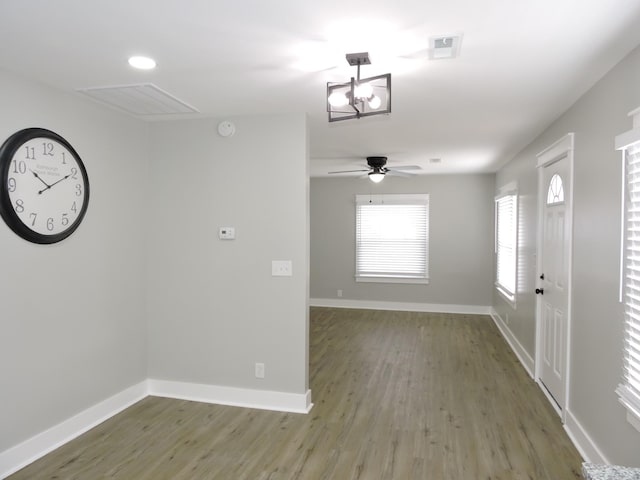 interior space with a chandelier and hardwood / wood-style floors