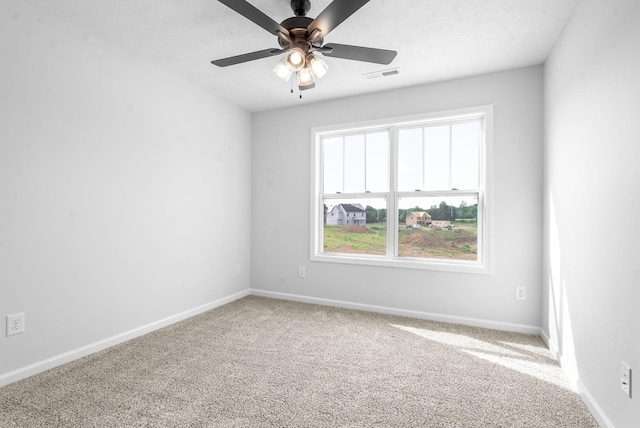 spare room with ceiling fan and carpet floors