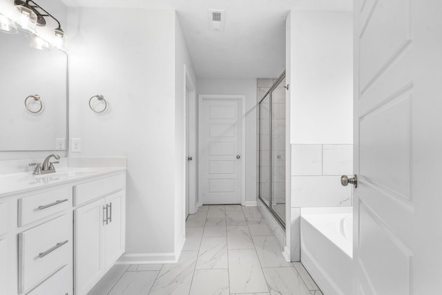 bathroom with a textured ceiling, vanity, and independent shower and bath