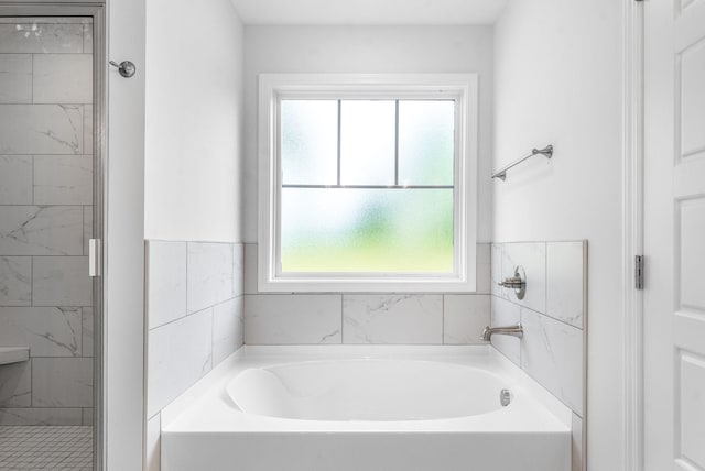 bathroom featuring a healthy amount of sunlight and shower with separate bathtub