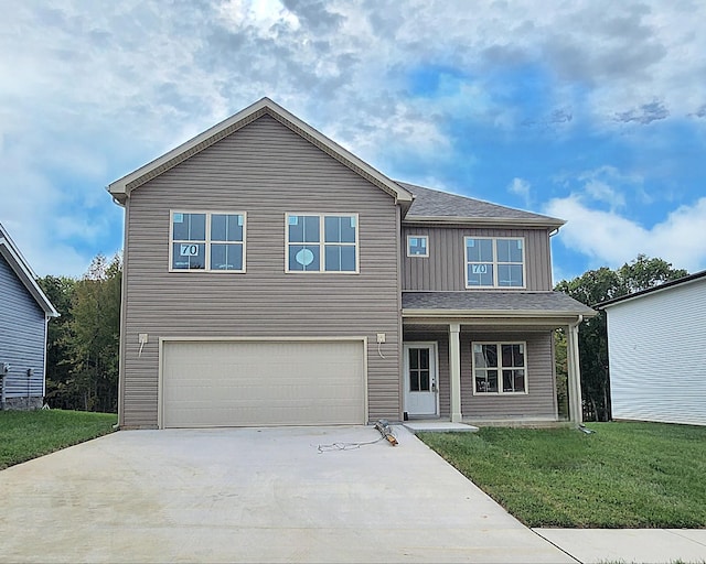 view of front of home with a garage and a front lawn