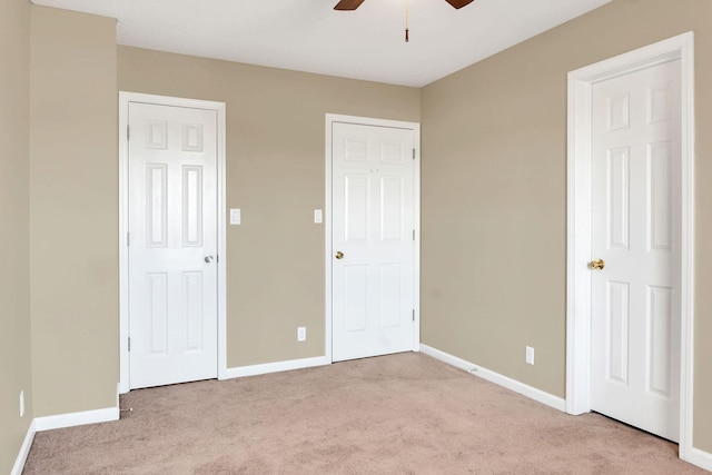 unfurnished bedroom featuring ceiling fan and light colored carpet