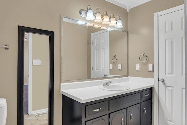 bathroom featuring vanity, toilet, and ornamental molding