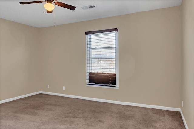 carpeted empty room featuring ceiling fan