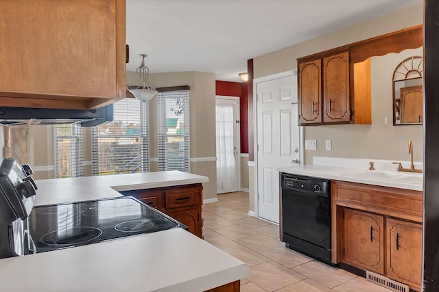 kitchen featuring sink, light tile patterned floors, dishwasher, range, and hanging light fixtures