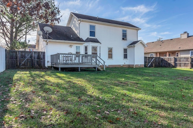 rear view of house with a wooden deck and a yard