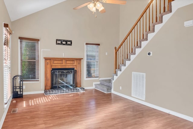 unfurnished living room featuring ceiling fan, high vaulted ceiling, and hardwood / wood-style flooring