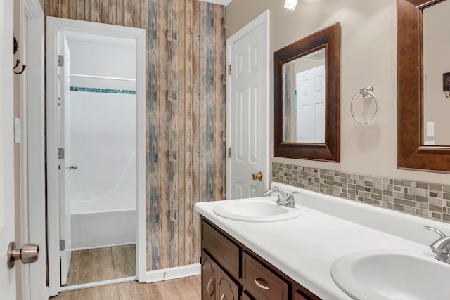 bathroom with decorative backsplash and vanity