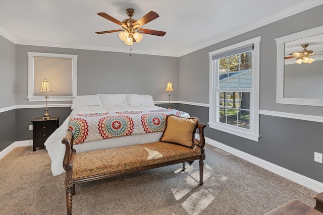 carpeted bedroom featuring ceiling fan and crown molding