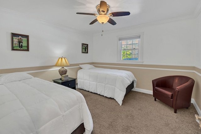 carpeted bedroom featuring ceiling fan and crown molding