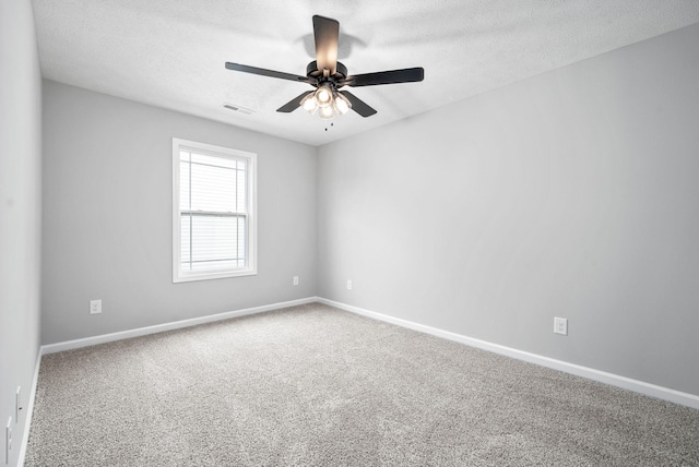 empty room featuring carpet flooring, a textured ceiling, and ceiling fan