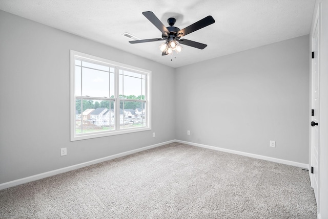 empty room featuring carpet flooring and ceiling fan