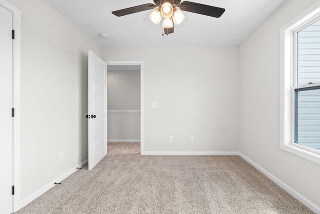 unfurnished bedroom with light colored carpet and ceiling fan