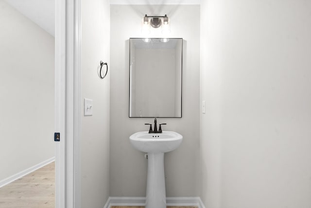 bathroom with hardwood / wood-style flooring