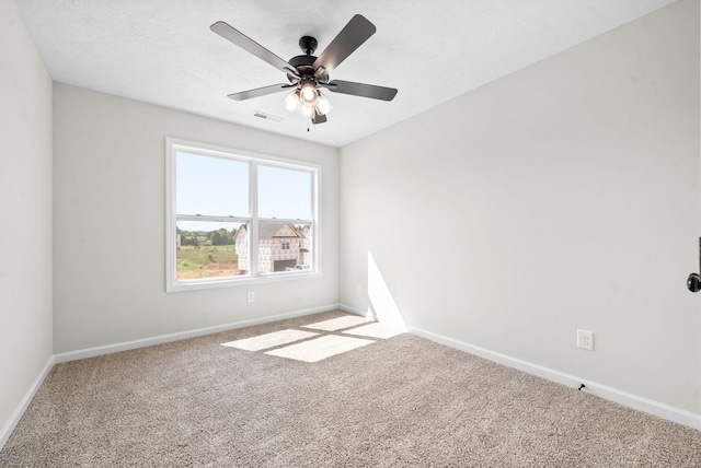 unfurnished room featuring ceiling fan and carpet floors