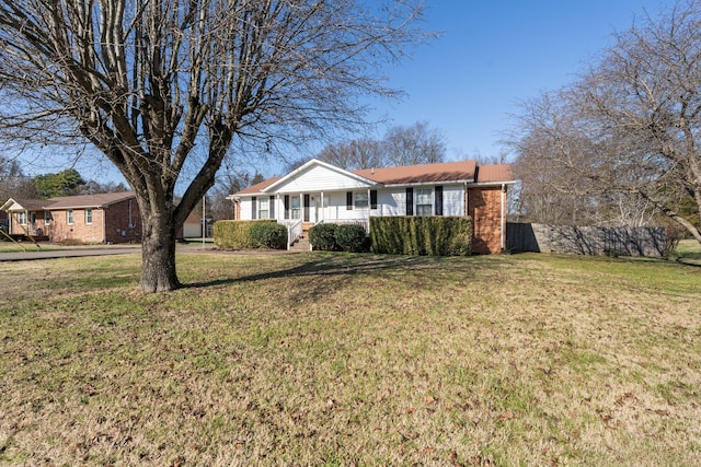 ranch-style house with covered porch and a front lawn