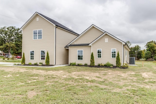 exterior space with a front lawn and central AC unit