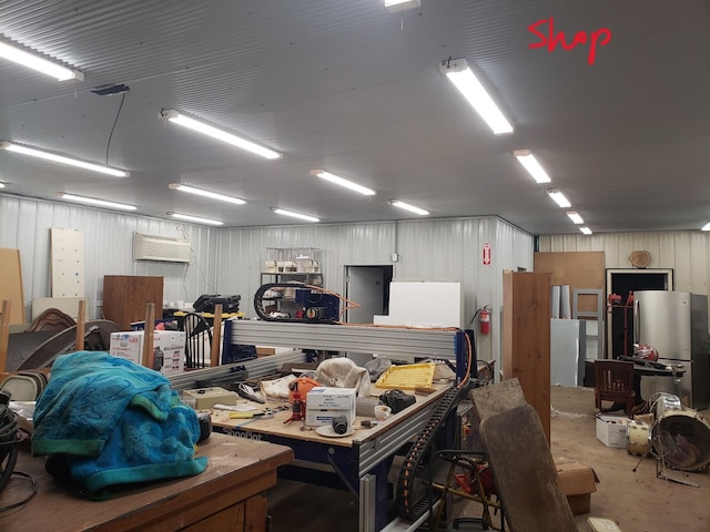 garage with a workshop area and stainless steel fridge