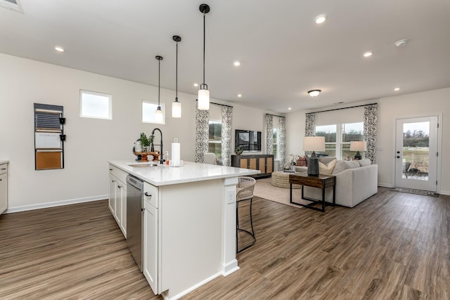 kitchen with sink, white cabinets, an island with sink, and dark hardwood / wood-style floors